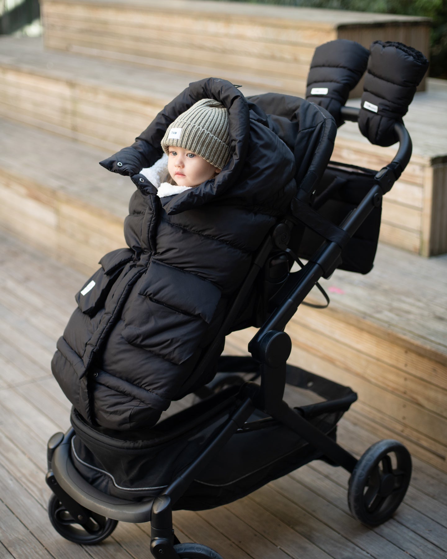kid in a stroller with footmuff