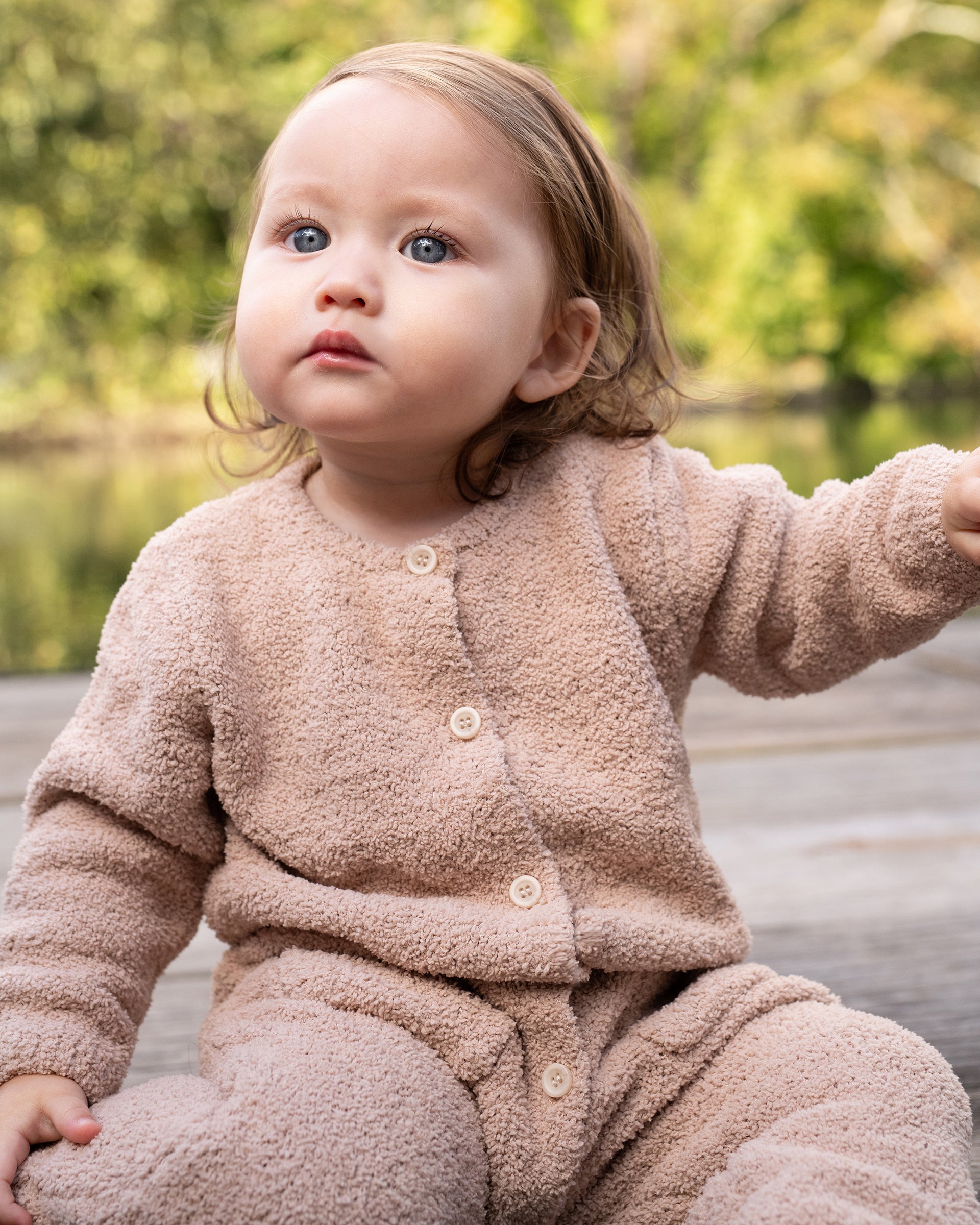 baby wearing oat jumpsuit
